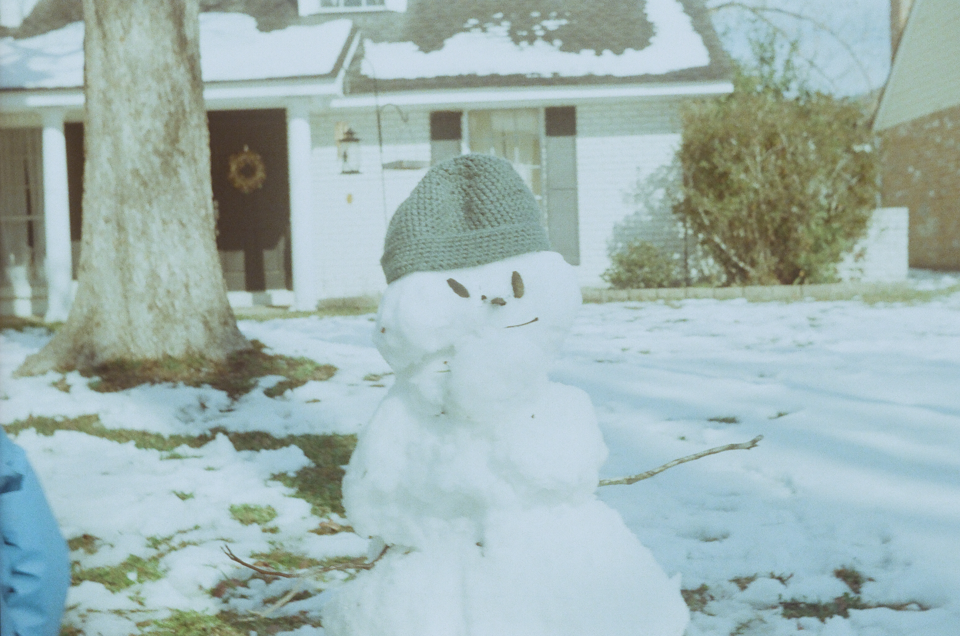 a snowman in front of a house