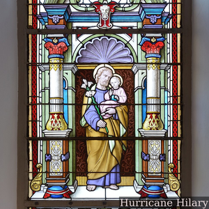 Saint Joseph depicted holding a staff with lily blossoms and the Christ Child on a stained-glass window in the Saint Antony church in Urtijëi. Today is St. Joseph's feast day in Western Christianity.